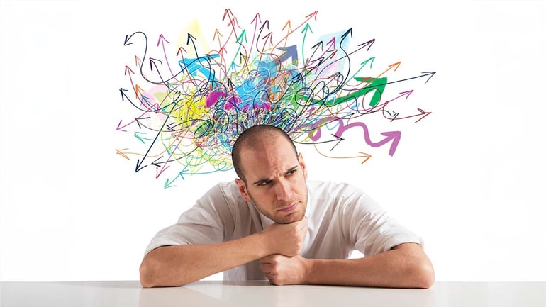 Confused man with tangle of arrows above him
