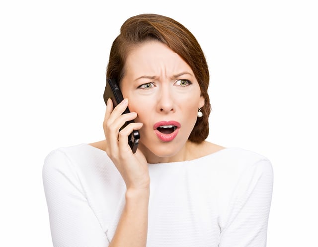 Closeup portrait young angry business woman, corporate employee talking on cell phone, having unpleasant, bad conversation, isolated white background. Negative emotions, facial expressions, reaction.jpeg