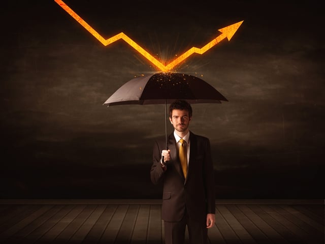 Businessman standing with umbrella keeping orange arrow concept on background.jpeg