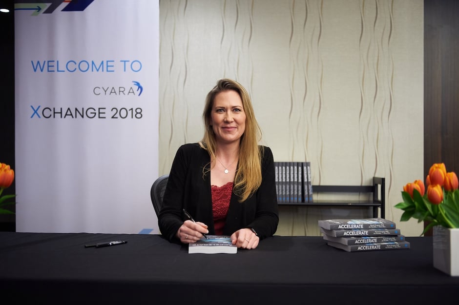 Dr. Nicole Forsgren signs copies of her new book at Cyara Xchange 2018